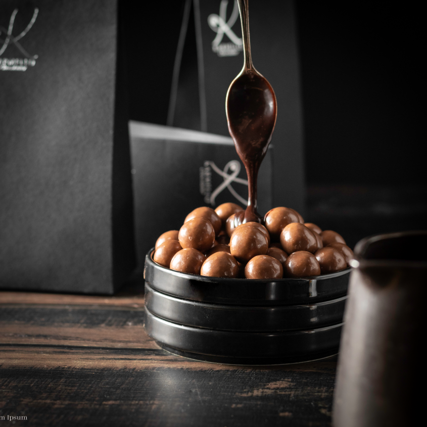 Almond in dark chocolate in a jar